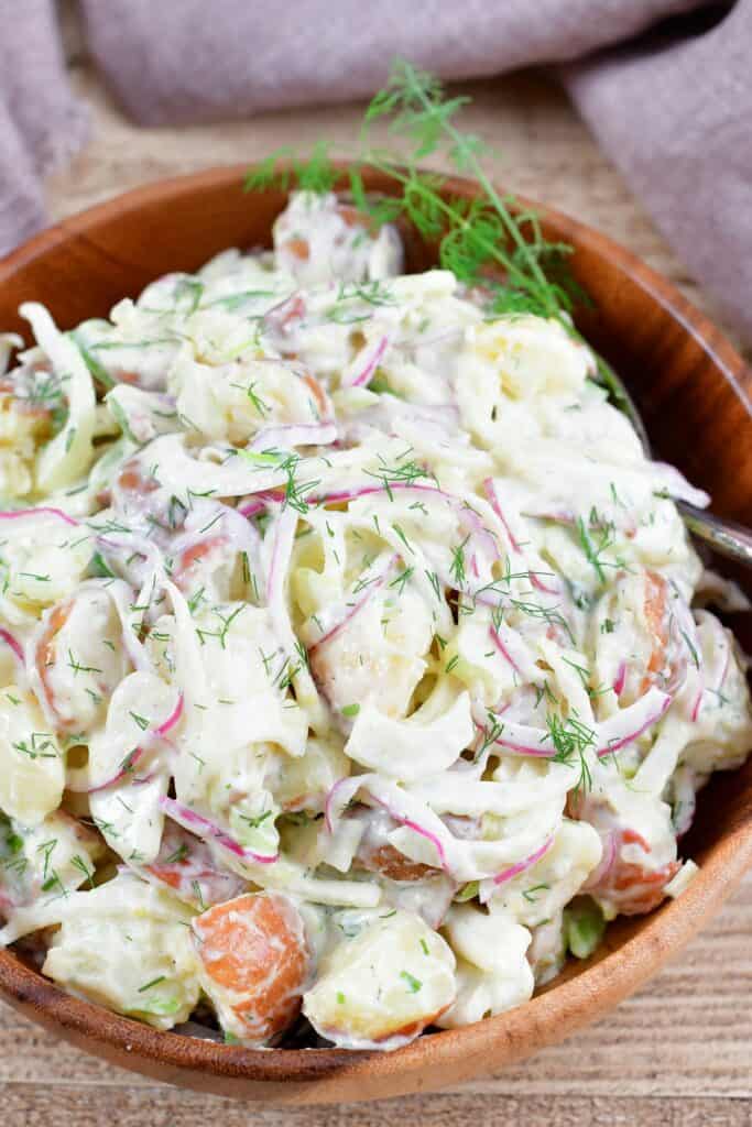 closeup of potato salad in a wooden bowl