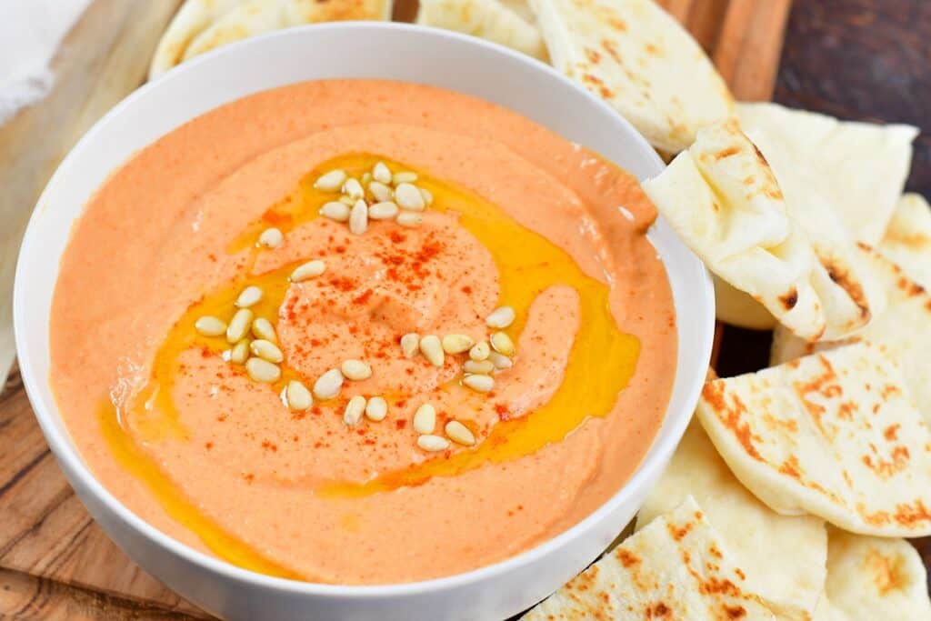 closeup of pink colored hummus in a bowl