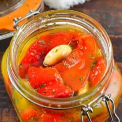 top view of roasted peppers and garlic in a jar