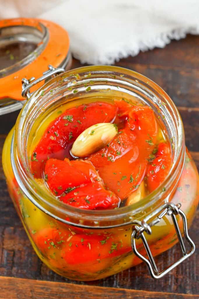 top view of roasted peppers and garlic in a jar