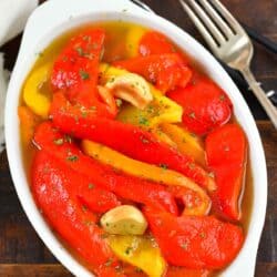 top view of roasted red peppers in oil in a bowl