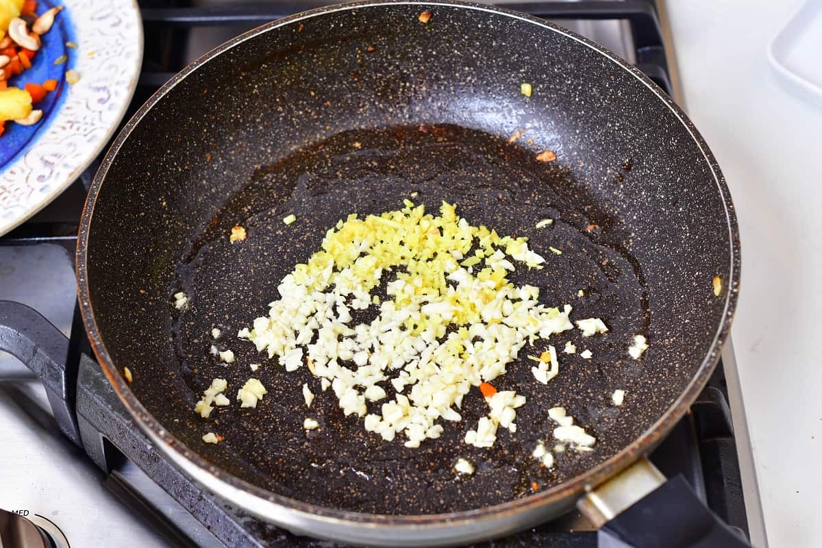 sautéing minced garlic and ginger in a pan