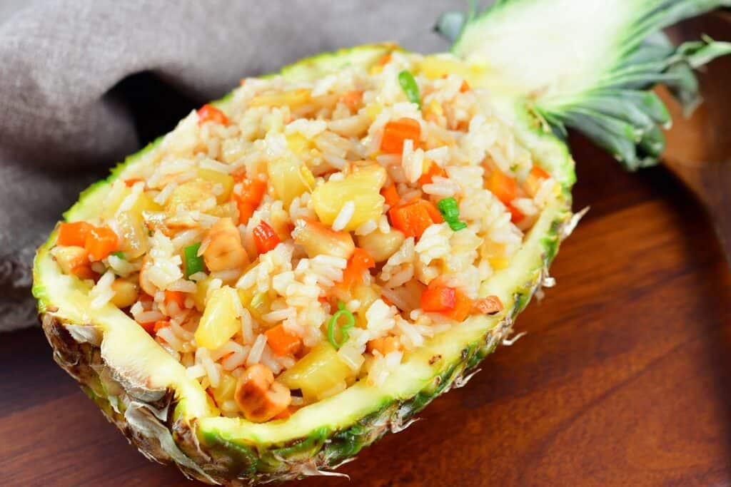 pineapple fried rice served inside a pineapple half