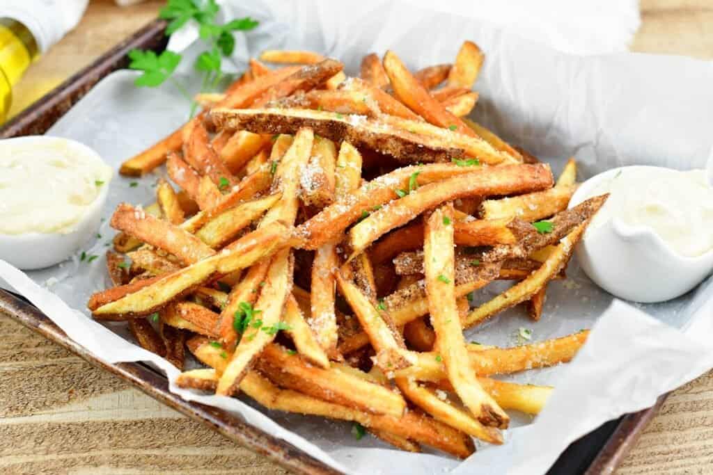 closeup of Parmesan coated truffle fries in parchment