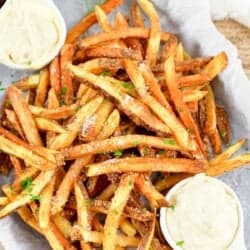 top view of truffle fries with two bowls of aioli