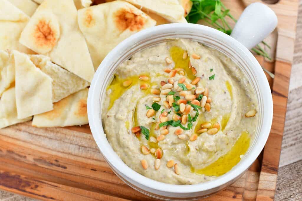 closeup of baba ganoush eggplant dip in a tan bowl