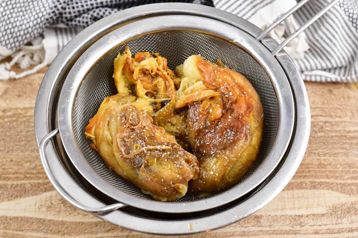 salted eggplant with skin off in a strainer