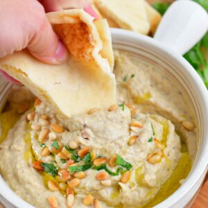 dipping into the baba ganoush dip with pita