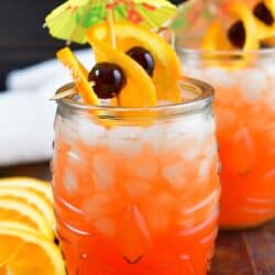 bright orange cocktail in a tiki glass with garnish