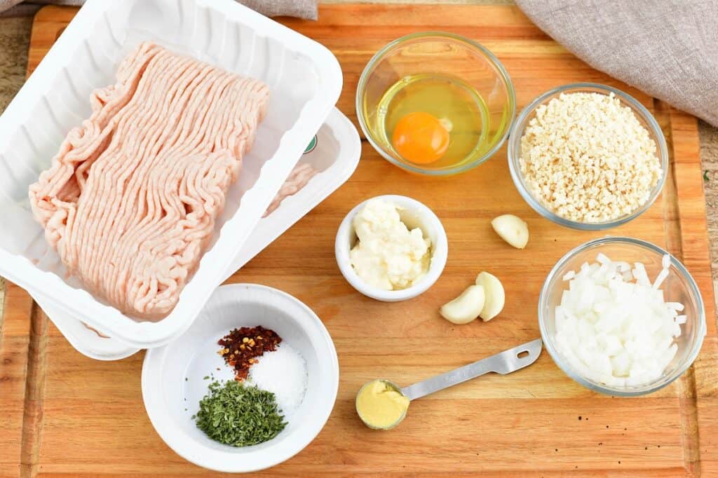 ingredients for chicken meatballs on the cutting board