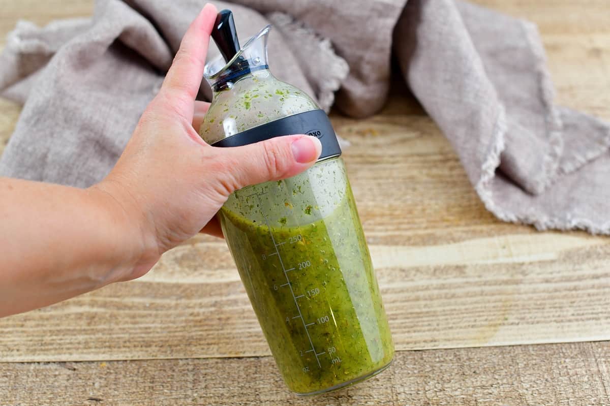 shacking the dressing in the salad dressing shaker