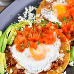 closeup view of the eggs over tortilla and tomato sauce