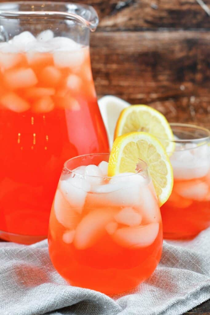 front view of pink lemonade in glasses and jar