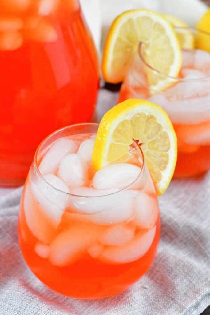 close top view of pink lemonade in a glass with lemon