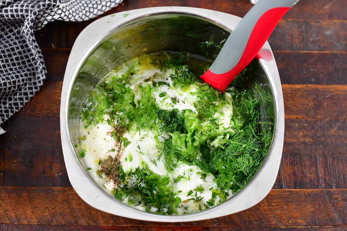 combining ingredients for tzatziki sauce in a bowl