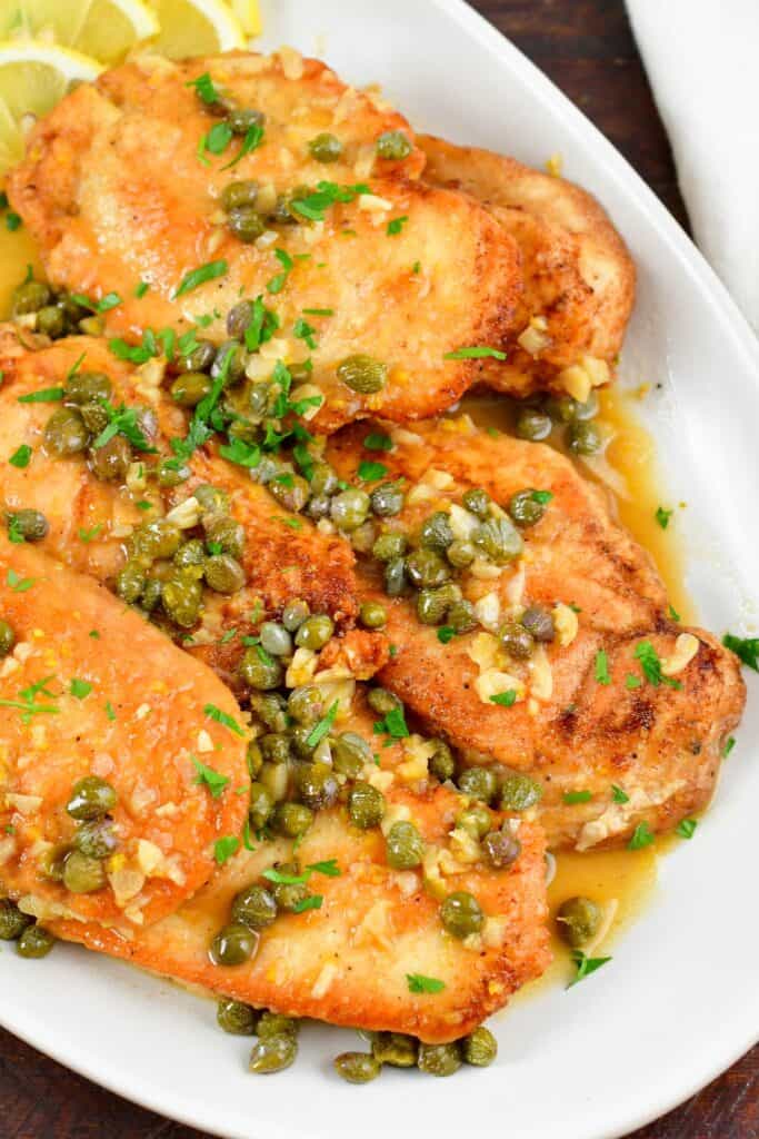 top view of chicken piccata in sauce on a plate