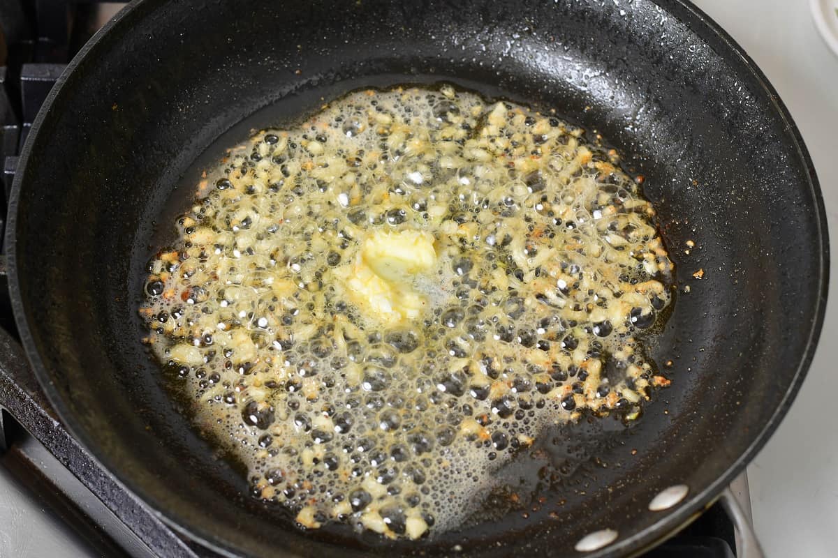 garlic searing in butter in a pan