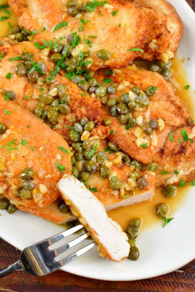 closeup of sliced chicken piccata on the plate