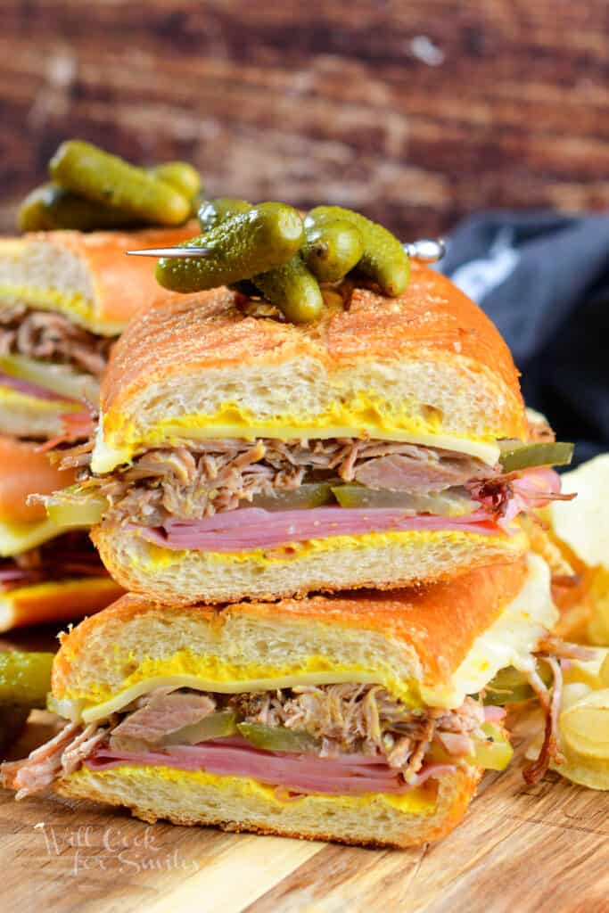 front view of the Cuban sandwich halves stacked with pickles on top
