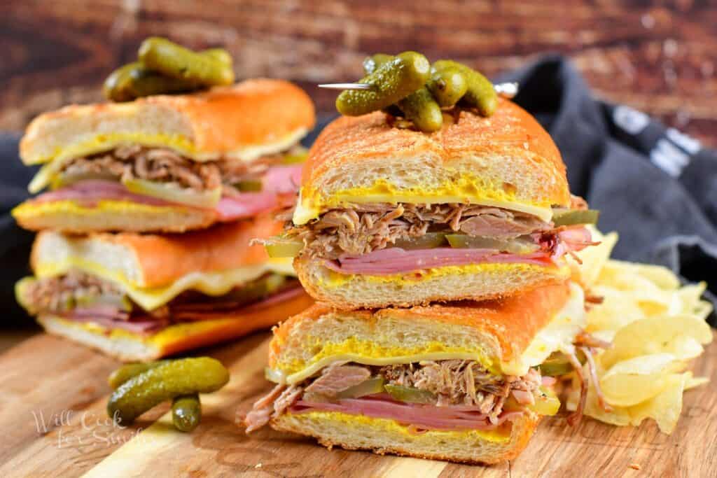 closeup of two Cuban sandwich halves stacked and more behind