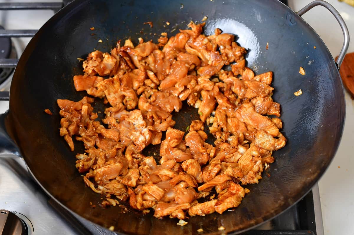 sautéing chicken in soy in a wok