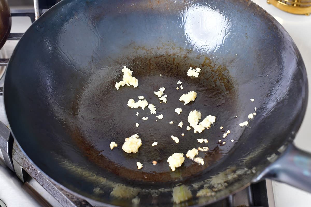 sautéing garlic in a wok