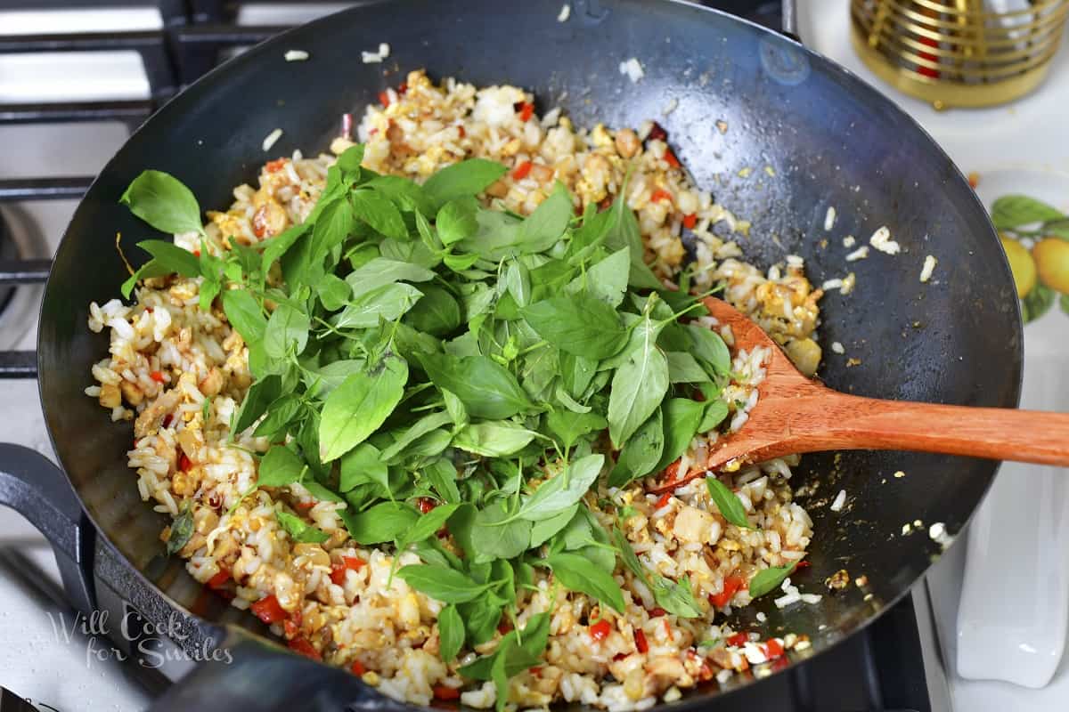 adding Thai basil to the work with other ingredients