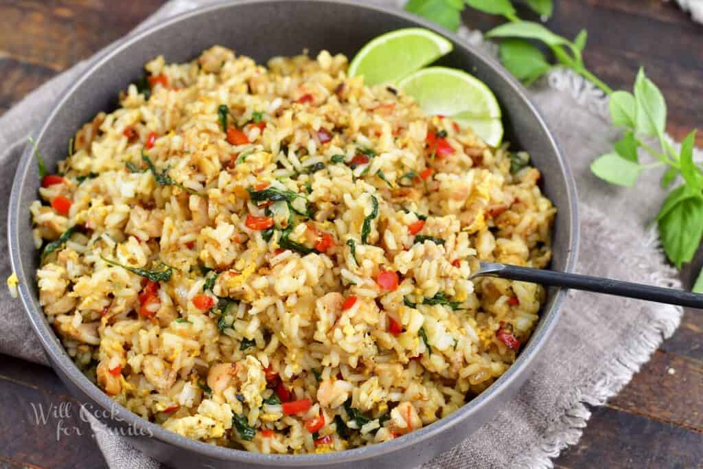 closeup of basil fried rice in a deep bowl with fork