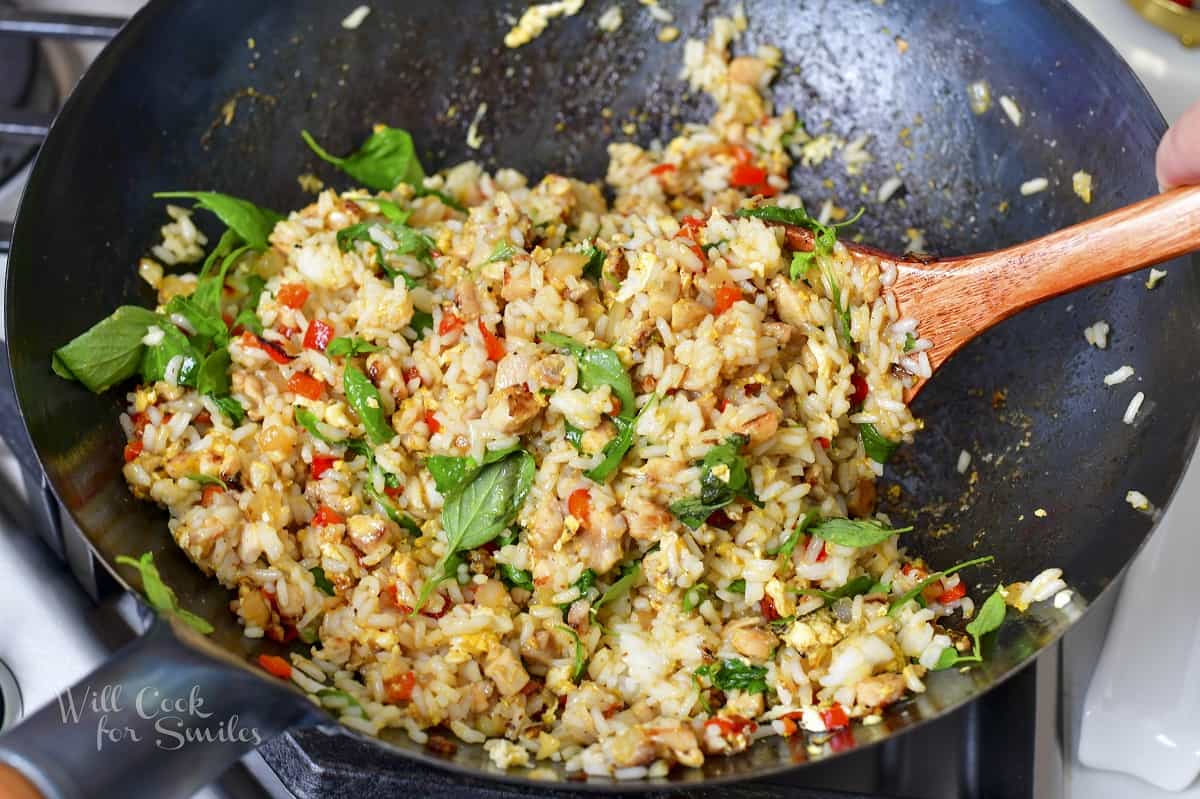 stirring all ingredients for basil fried rice in a wok