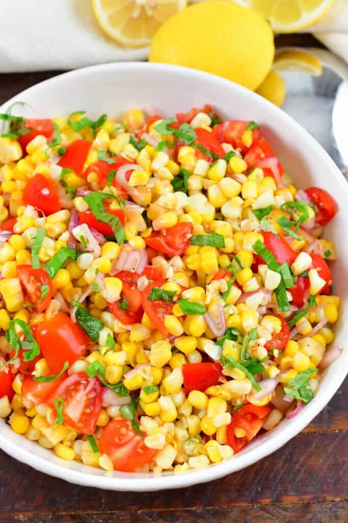 top view of the tomato corn salad in a white bowl