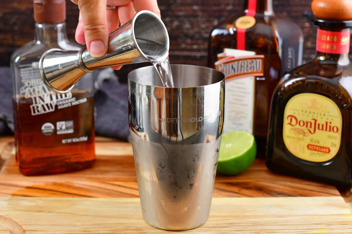 pouring tequila into the cocktail shaker