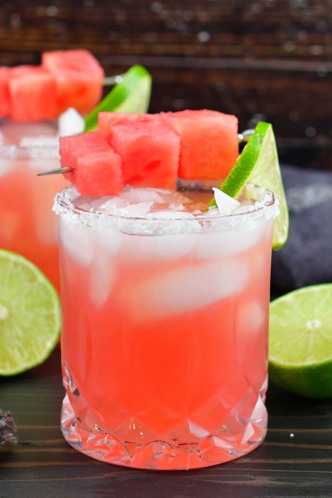 closeup watermelon margarita in a glass with salt