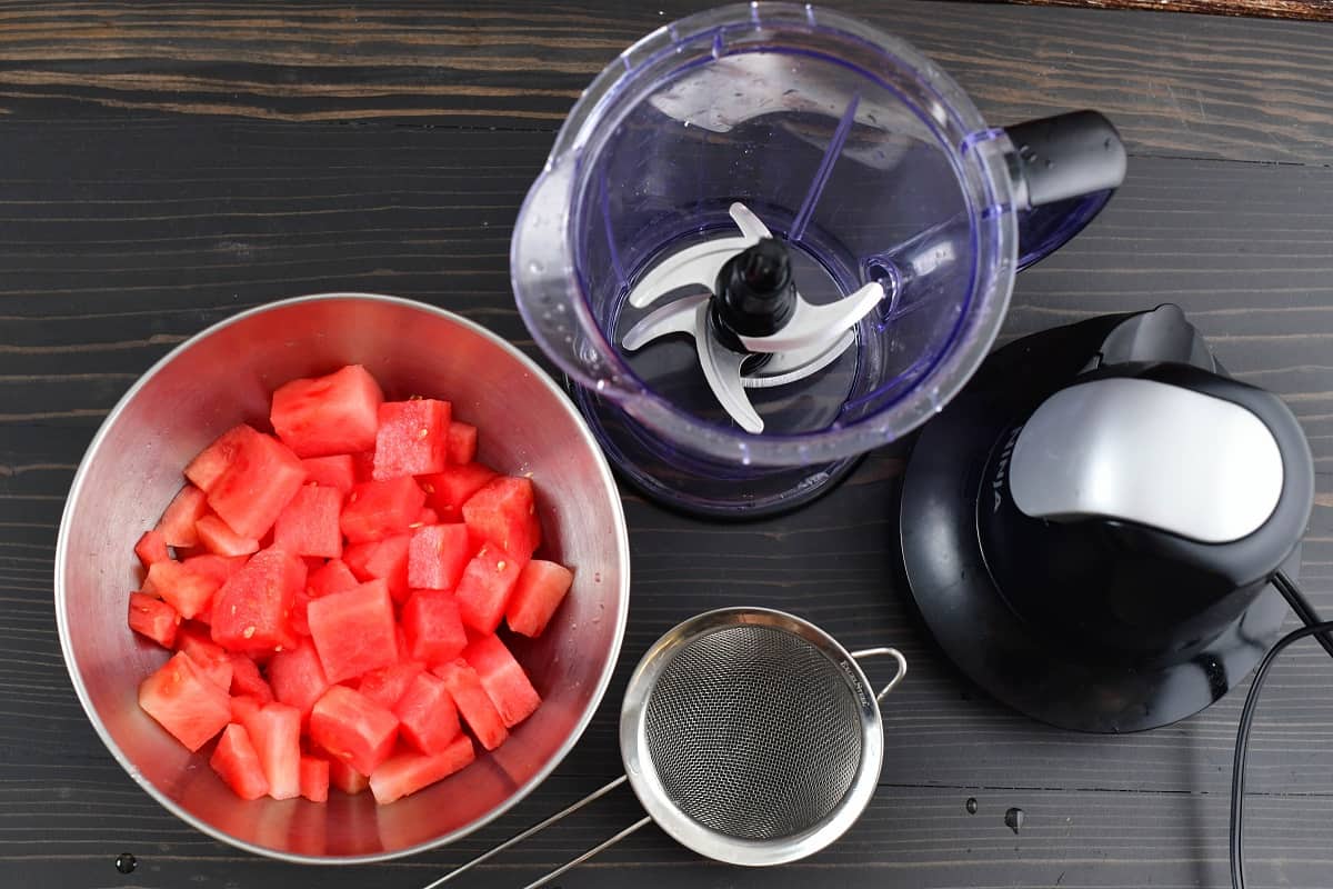 watermelon chunks in a bowl next to the blender