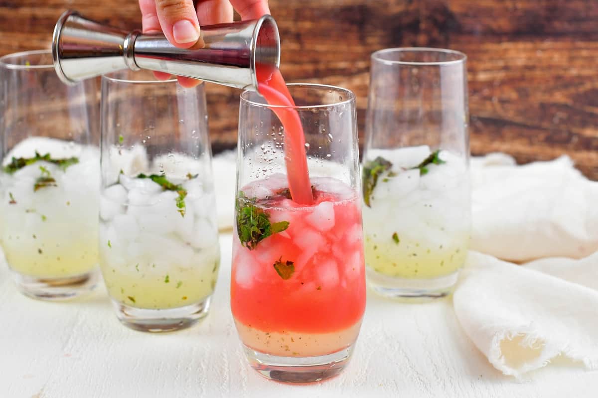 adding watermelon juice to the glasses