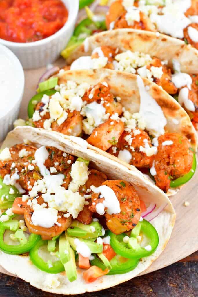 closeup of grilled shrimp tacos stacked