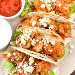 top view of four grilled shrimp tacos