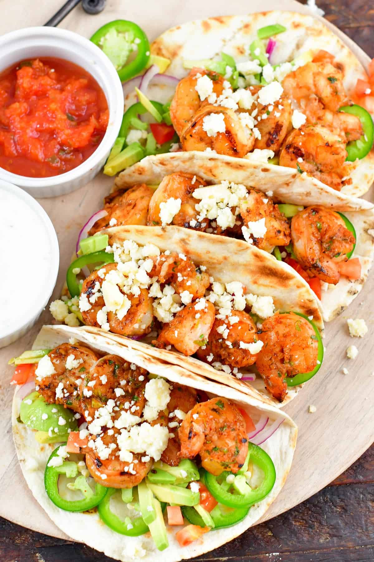 top view of four grilled shrimp tacos