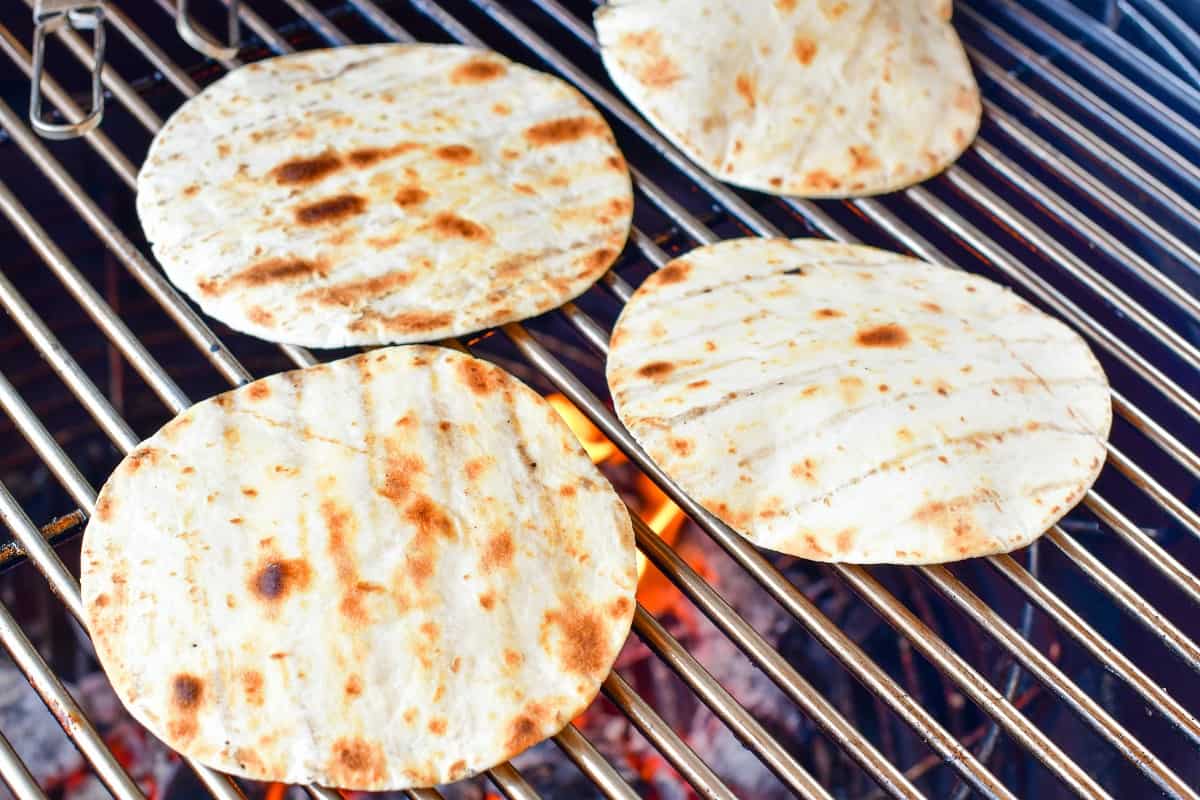tortillas warming on the grill