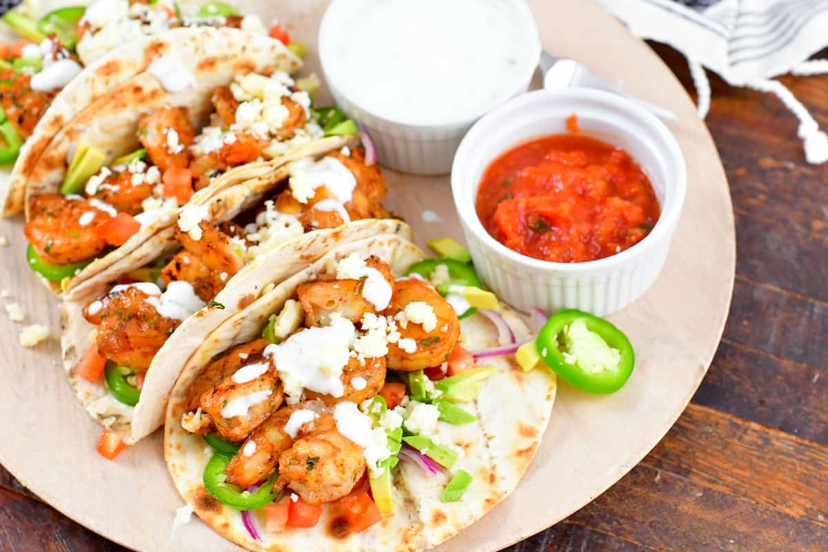 horizontal view of the shrimp tacos with sauces