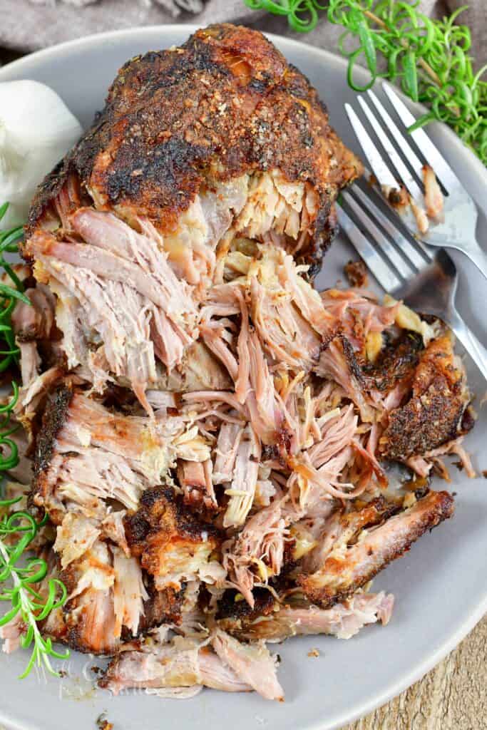 closeup of shredded tender roasted pork on the plate.