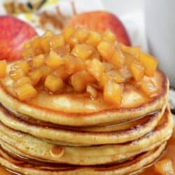 stack of pancakes topped with apple topping