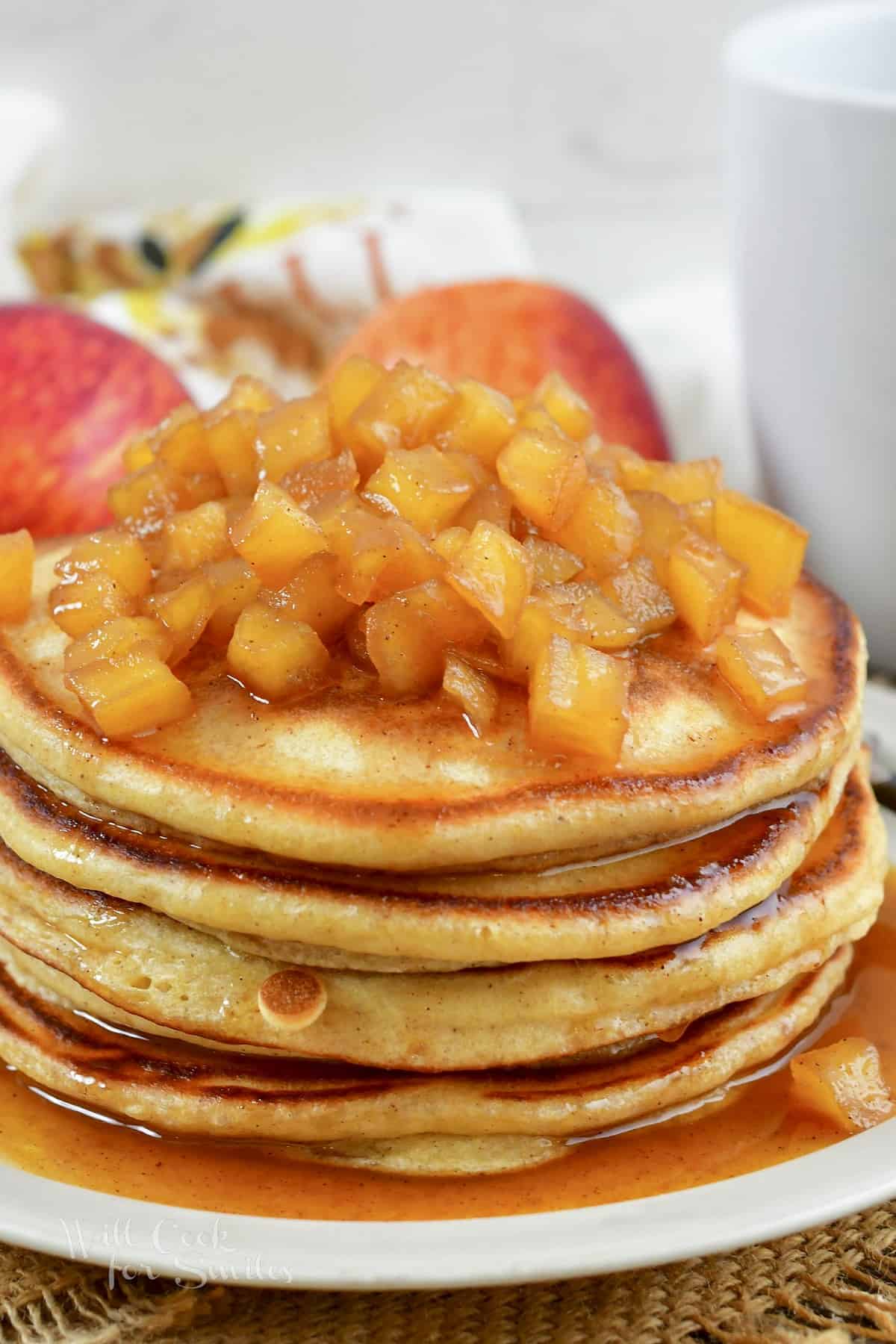 stack of pancakes topped with apple topping
