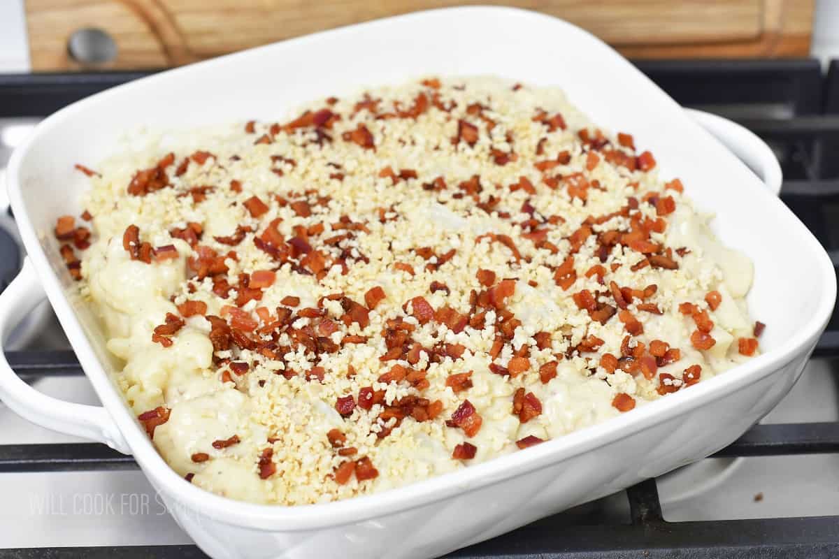 cauliflower casserole spread in baking dish with topping.