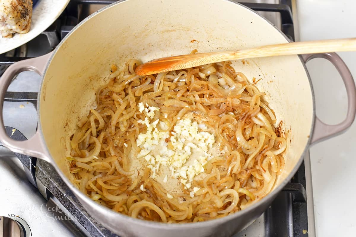 adding garlic to the sautéed onions