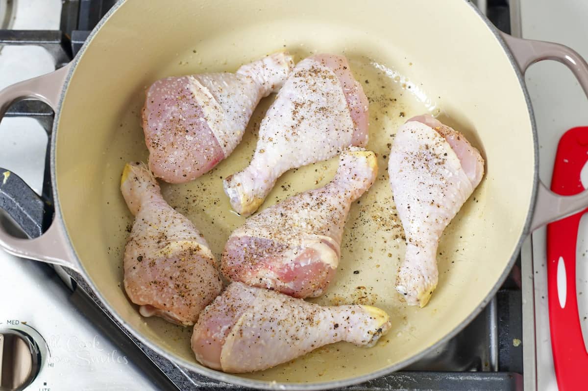 six seasoned drumsticks added to the Dutch oven