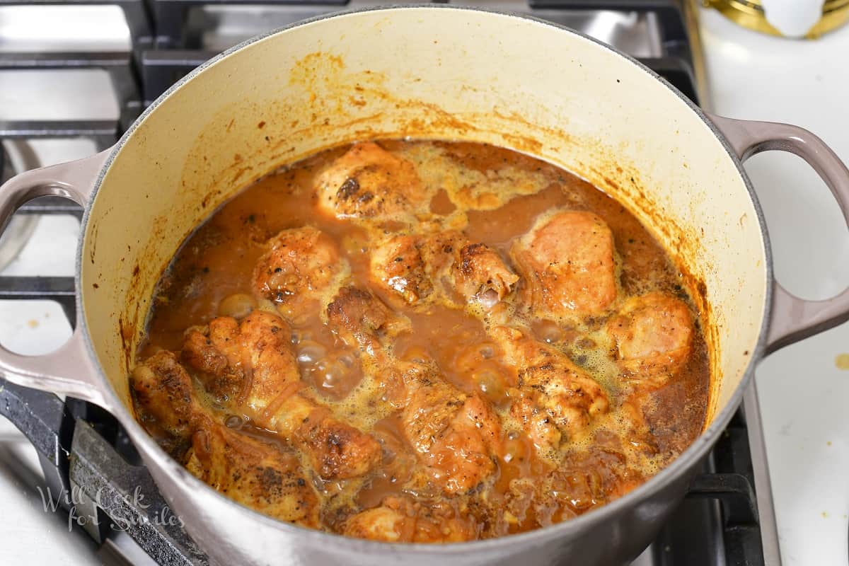 stewed chicken in the sauce in a Dutch oven