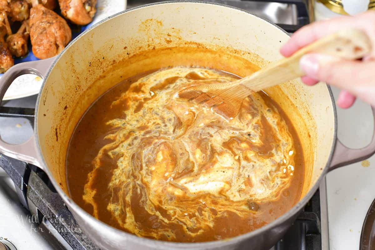 stirring in sour cream into the brown sauce