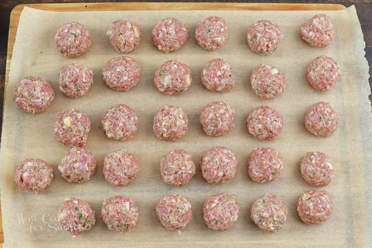 shaped meatballs laid out on the parchment paper