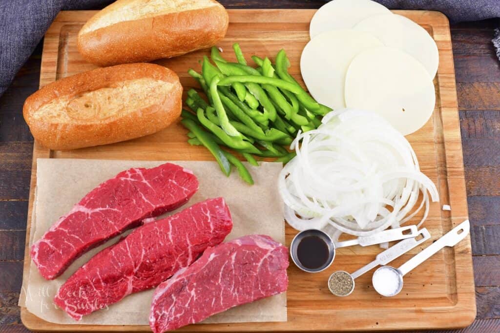 ingredients for Philly cheesesteaks on the cutting board