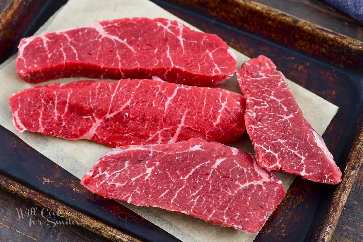 par-frozen steaks on the baking sheet